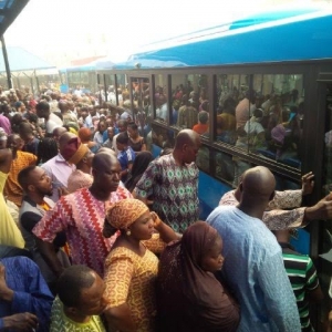 Commuters trying to get on a bus