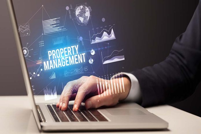 Businessman working on laptop with PROPERTY MANAGEMENT inscripti